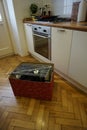 Kitchen with deal crate wooden parquet and table with flowers and home appliances