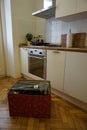 Kitchen with deal crate wooden parquet and table with flowers and home appliances