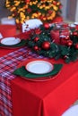 kitchen decorated with pine garlands and Christmas toys. the table and near is worth Christmas tree. interior bright kitchen Royalty Free Stock Photo