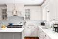 A kitchen detail with cream cabinets and a marble subway tile backsplash. Royalty Free Stock Photo