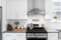 A kitchen detail with white cabinets and subway tile backsplash. Royalty Free Stock Photo