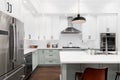 A kitchen detail with white and sage green cabinets.