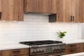 A kitchen detail with wood cabinets and white subway tile backplash. Royalty Free Stock Photo