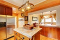 Kitchen and dining room interior with brown wooden cabinets and dining table set. Royalty Free Stock Photo