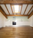 Kitchen in empty apartment with wooden beams Royalty Free Stock Photo