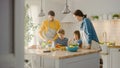 In Kitchen: Family of Four Cooking Together Healthy Dinner. Mother, Father, Little Boy and Girl, P Royalty Free Stock Photo