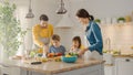 In Kitchen: Family of Four Cooking Together Healthy Dinner. Mother, Father, Little Boy and Girl, P Royalty Free Stock Photo