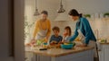 In Kitchen: Family of Four Cooking Together Healthy Dinner. Mother, Father, Little Boy and Girl, P Royalty Free Stock Photo