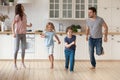 Family with little kids dancing in the kitchen Royalty Free Stock Photo