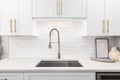 A white kitchen faucet detail with a subway tile backsplash. Royalty Free Stock Photo