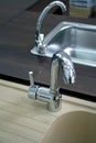 Kitchen faucets with stainless steel sink Royalty Free Stock Photo