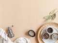 Kitchen flat lay of small bowls various dry spices, napkin and metal spice mill on a beige background. Top view. copy space