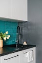 kitchen with flowers in vase and water tap in stylish apartment