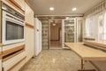 A kitchen full of light colored column cabinets with wooden bevels and moldings Royalty Free Stock Photo