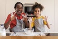 Kitchen Fun. Cheerful Black Father And Daughter Fooling Together While Baking