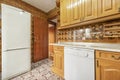 kitchen furnished with Castilian-style wooden furniture and striking vintage tiles on floors and walls