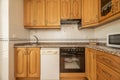 Kitchen furnished with vintage wooden furniture, pink granite countertop