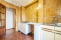 Kitchen furnished with white base units, gas stove, sapelly wood doors with glass windows and two-tone brown stoneware on the Royalty Free Stock Photo