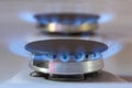 Kitchen gas burners blue flames of natural gas, domestic equipment with propane or methane gas Royalty Free Stock Photo