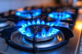 Kitchen gas stove burner with blue flame. Gas cooker with burning flames of propane gas. Global gas crisis and price rise Royalty Free Stock Photo