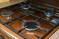 Kitchen gas stove and gas burners with blue flame, natural gas market concept Royalty Free Stock Photo