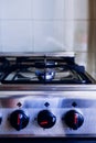 Kitchen gas stove, cooking stove with a burning blue flame and fire power control knobs