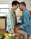 This kitchen is getting a tad hot. a affectionate young couple preparing a meal together in their kitchen. Royalty Free Stock Photo