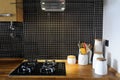 Kitchen with Black Tiles and Wooden Counter, Natural Worktop, Home Stove Royalty Free Stock Photo