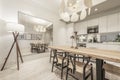 Kitchen with gray cabinets with white stone countertop, mirrored wall, Royalty Free Stock Photo