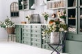 Kitchen in green white theme full of flowers Royalty Free Stock Photo
