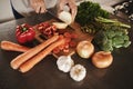 Kitchen, hands and knife with vegetables, chopping board and food with ingredients and diet plan. Closeup, utensils or Royalty Free Stock Photo