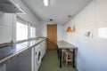 Kitchen of a house with sloping ceilings with green wooden table, pine