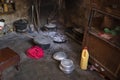 The kitchen inside a hut. African kitchen interior with hearth and stove. Interior of the modest vintage style poor kitchen, pots