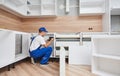 kitchen installation. Worker assembling furniture Royalty Free Stock Photo