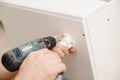 Kitchen installation, worker twists legs for box