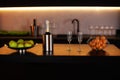 Kitchen interior with kitchen area with an island in loft style in dark colors. Champagne bottle in bucket with ice and glasses of Royalty Free Stock Photo