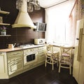 Kitchen interior in bright colors stove refrigerator chairs