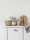 Kitchen interior - cans of pasta, flour in a metal basket, dishwashers, cutting boards, napkin on a white table