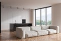 Kitchen interior with countertop, couch and bar chairs near panoramic window