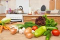 Kitchen interior with fresh fruits and vegetables on the table, healthy food concept Royalty Free Stock Photo