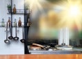 Kitchen interior with retro kitchenware and utensils. Shelves with bottles of drinks and sauces on the wall. Royalty Free Stock Photo