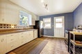 Kitchen interior with white cabinets and bright navy walls