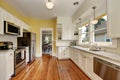 Kitchen interior with white cabinets, yellow walls and wood floor Royalty Free Stock Photo
