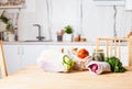 Kitchen interiour and table with groceries in textile bags