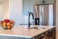 Kitchen island with black curved faucet and stainless steel double bowl sink Royalty Free Stock Photo