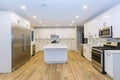 Kitchen with island sink cabinets, and hardwood floors in new luxury home three kitchen sinks Royalty Free Stock Photo