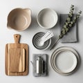 Kitchen items arranged on a white surface. Includes beige and white ceramic bowls, two wooden Royalty Free Stock Photo