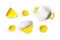 Yellow ceramic crockery tableware with fresh lemons isolated on white background