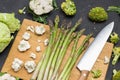 Kitchen knife and asparagus on cutting board Royalty Free Stock Photo