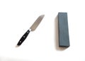 Kitchen knife and sharpening stone on a white background- image Royalty Free Stock Photo